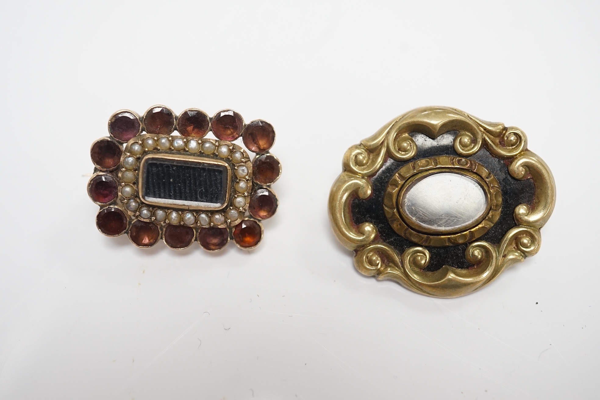 Three assorted late 19th/early 20th century yellow metal mounted mourning brooches, including black enamel and split pearl inscribed 'JMMM. BJBW. JBMW. 23rd Oct Gallipoli 1915', 45mm and a garnet and split pearl. Conditi